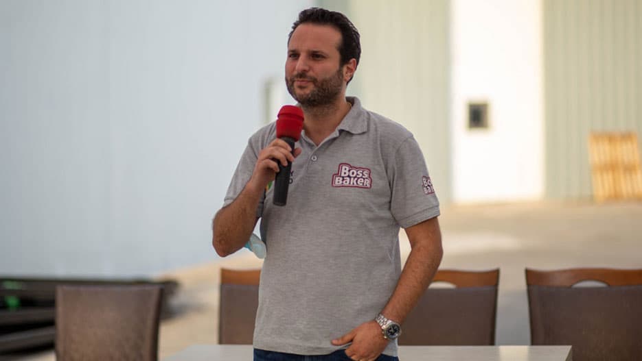 Geoffrey Fadoul speaking into a microphone